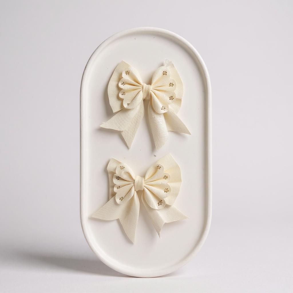 Par de moños chicos hueso